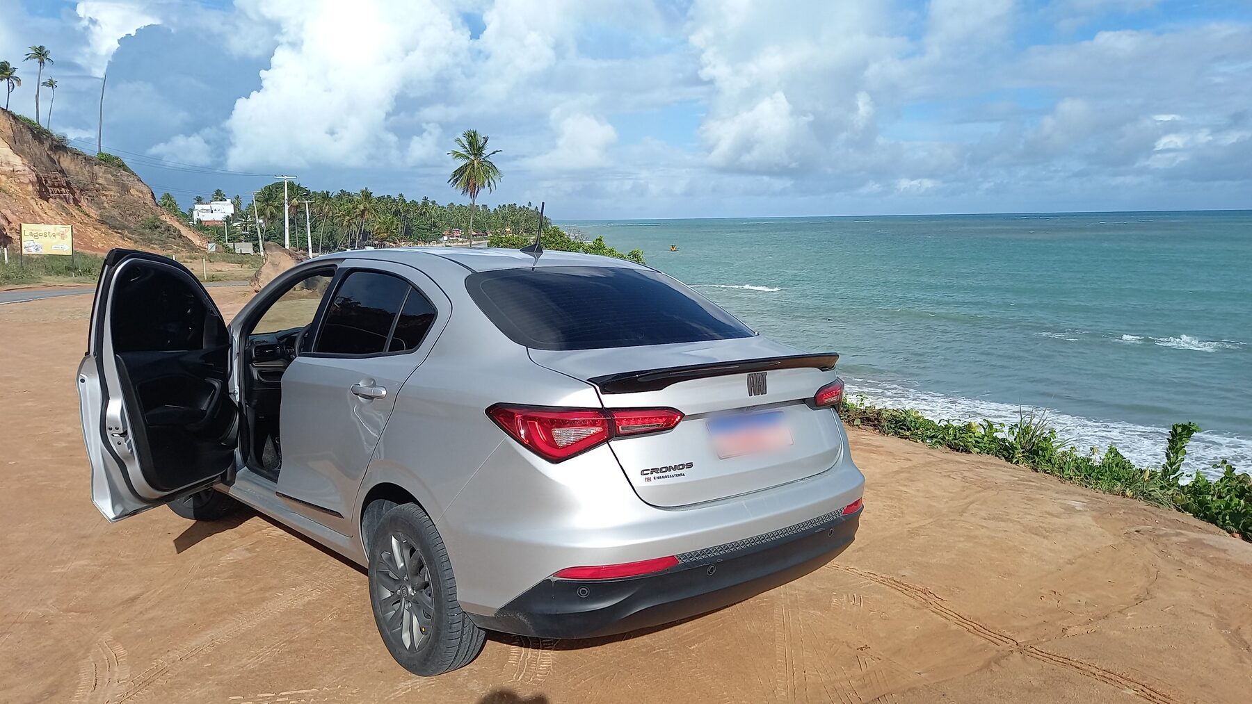 Carro de translado estacionado em um mirante à beira-mar
